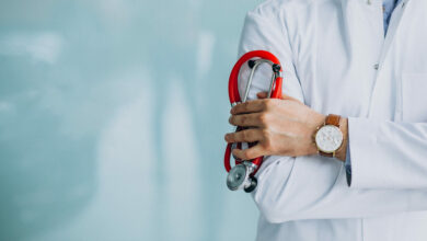 young handsome physician in a medical robe with stethoscope scaled 1